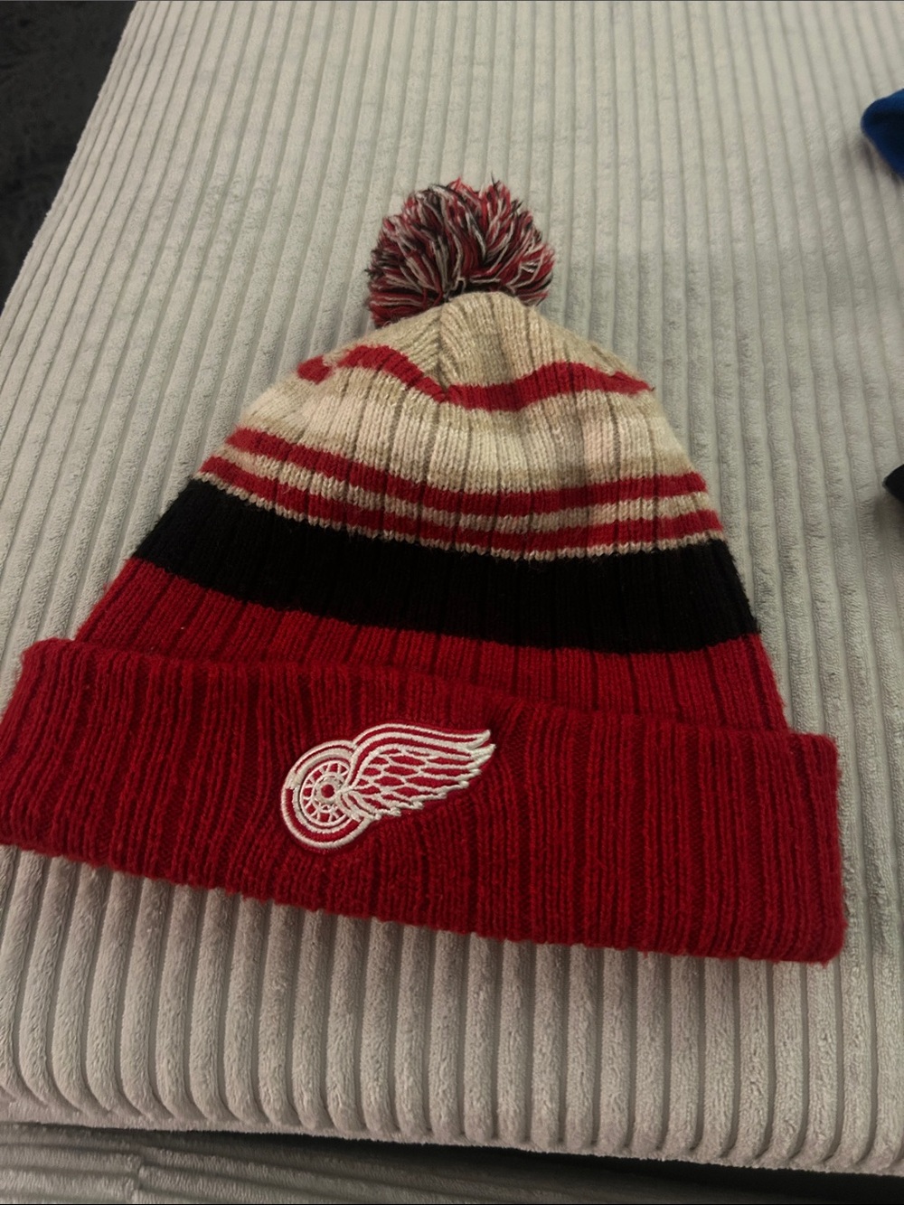 Men's Red Striped Pom-Pom Knit Beanie Hat with Winged Wheel Logo